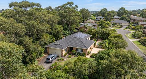 High angle shot of leafy residential home in Castle Hill surrounded by dense gum trees with clean roof gutters